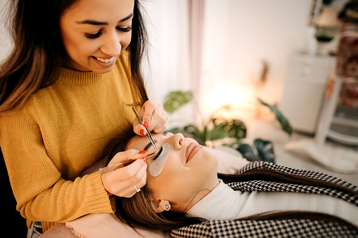 Shot of a young woman getting eyelash extensions